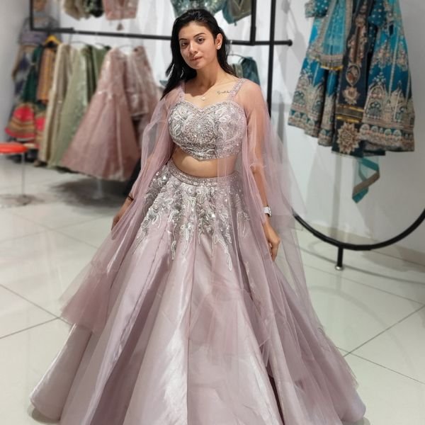Pastel pink bridal lehenga choli with heavy embroidery and net dupatta for bride - Radharani Vastralaya