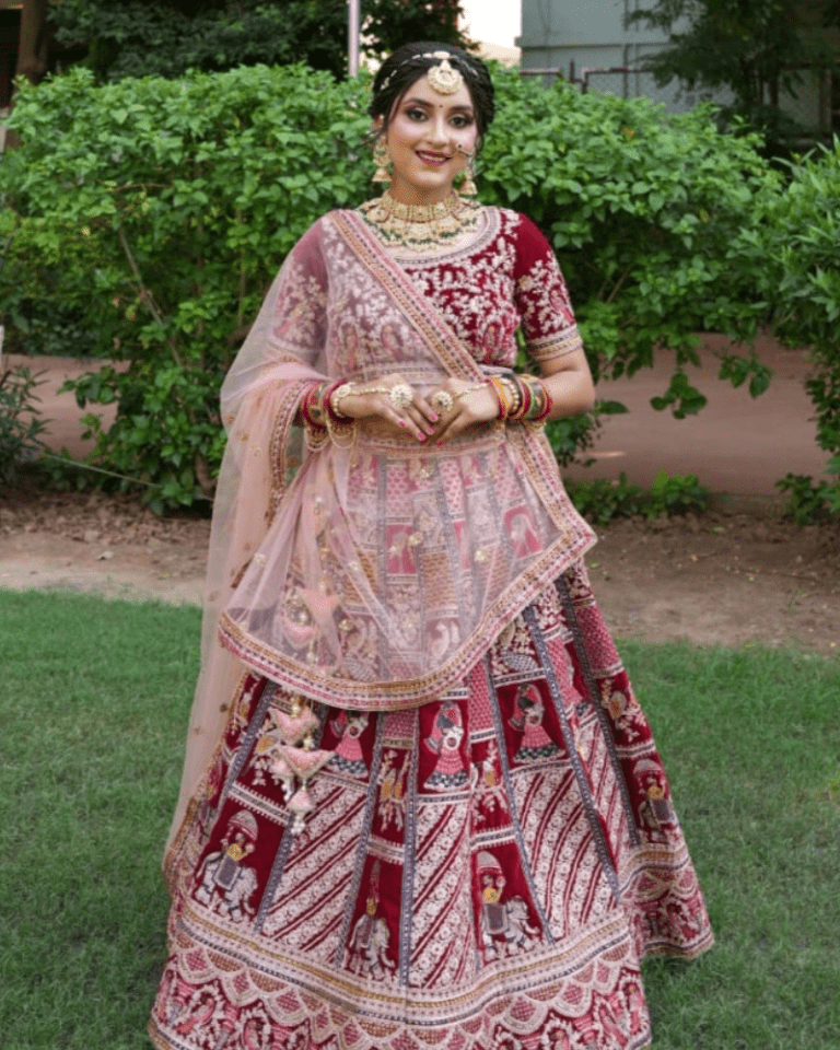 Royal maroon bridal lehenga with intricate embroidery for a stunning wedding look.